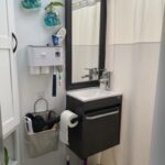 RV restroom remodel with a new sink, pain, curtain shower and decorations.